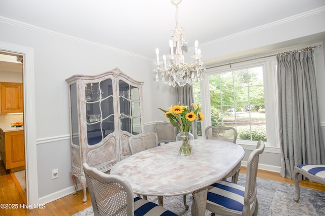 7 Saddle Pl, Pinehurst, NC 28374 - dining area with a chandelier, light wood-style floors, and crown molding