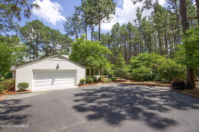 7 Saddle Pl, Pinehurst, NC 28374 - view of front of home with asphalt driveway, a garage, and brick siding