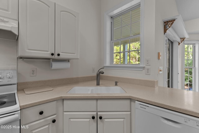 3665 Willow Lake Dr SE, Southport, NC 28461 - kitchen featuring white appliances, a sink, white cabinets, ventilation hood, and light countertops