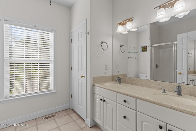 3665 Willow Lake Dr SE, Southport, NC 28461 - bathroom with double vanity, plenty of natural light, a shower stall, and tile patterned floors