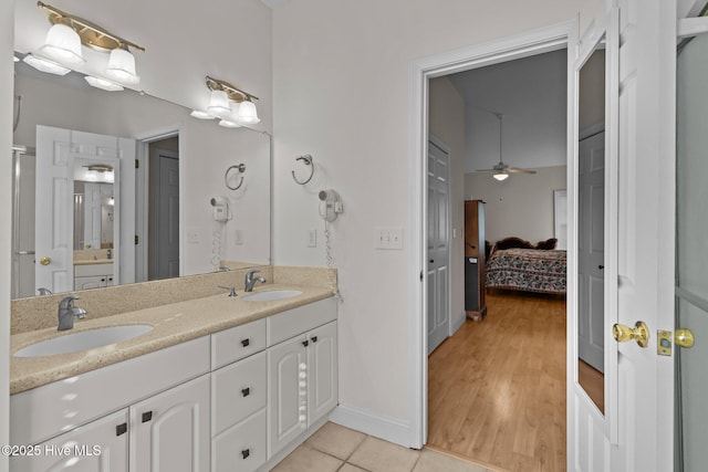 3665 Willow Lake Dr SE, Southport, NC 28461 - bathroom featuring double vanity, a ceiling fan, ensuite bathroom, tile patterned flooring, and baseboards
