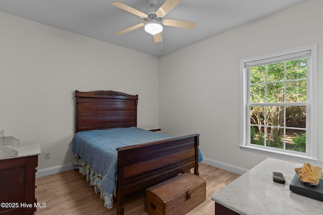 3665 Willow Lake Dr SE, Southport, NC 28461 - bedroom featuring baseboards, light wood-type flooring, and a ceiling fan