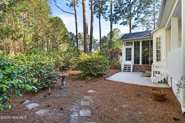3665 Willow Lake Dr SE, Southport, NC 28461 - view of yard featuring a sunroom and a patio area