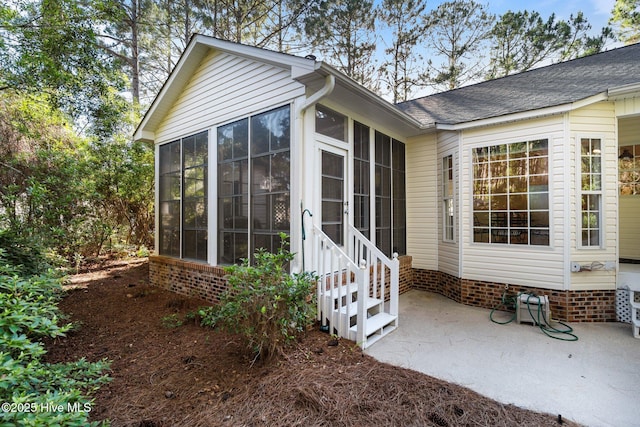 3665 Willow Lake Dr SE, Southport, NC 28461 - entrance to property with a patio and a shingled roof
