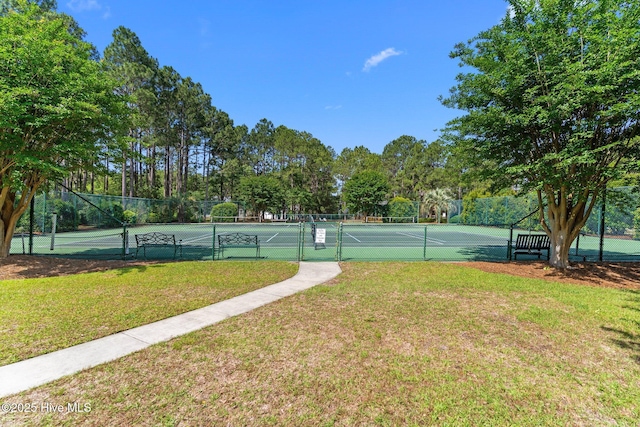 3665 Willow Lake Dr SE, Southport, NC 28461 - view of tennis court featuring view of wooded area