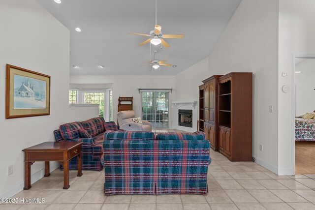 3665 Willow Lake Dr SE, Southport, NC 28461 - living area with a ceiling fan, baseboards, a fireplace, light tile patterned flooring, and high vaulted ceiling