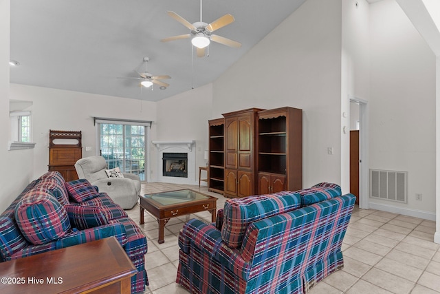3665 Willow Lake Dr SE, Southport, NC 28461 - living room featuring ceiling fan, high vaulted ceiling, light tile patterned floors, a fireplace, and baseboards