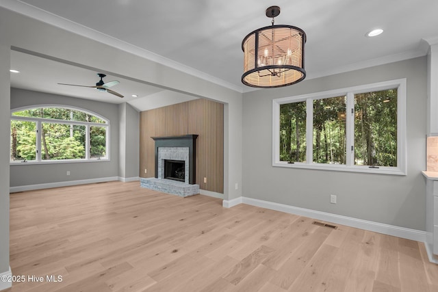 101 Marshview Rd, Hampstead, NC 28443 - unfurnished living room with baseboards, light wood finished floors, a ceiling fan, ornamental molding, and a fireplace