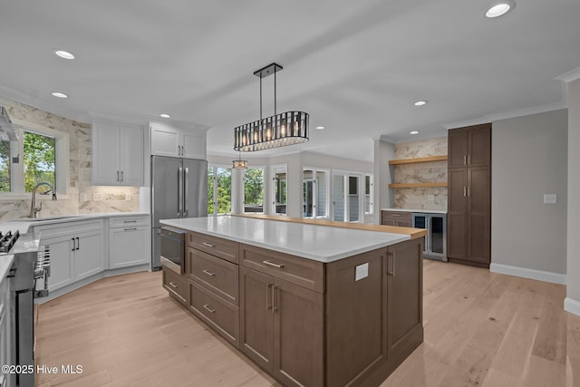 101 Marshview Rd, Hampstead, NC 28443 - kitchen featuring a sink, high end refrigerator, backsplash, white cabinetry, and recessed lighting