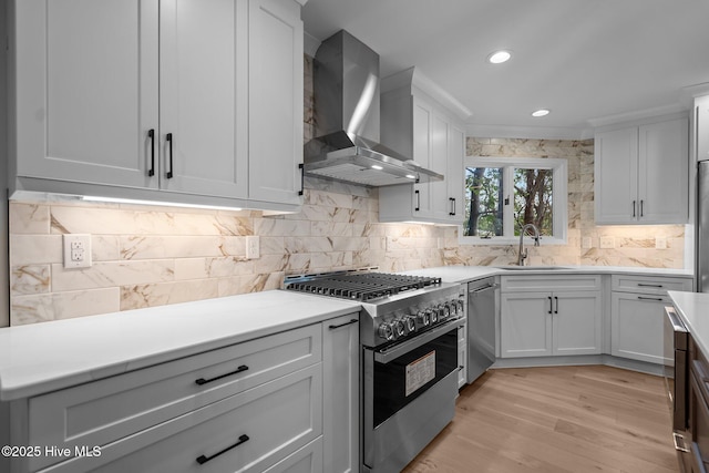 101 Marshview Rd, Hampstead, NC 28443 - kitchen with stainless steel appliances, wall chimney range hood, a sink, decorative backsplash, and recessed lighting