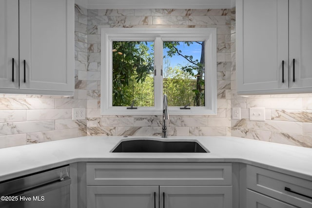 101 Marshview Rd, Hampstead, NC 28443 - kitchen featuring dishwasher, a sink, light countertops, decorative backsplash, and white cabinets