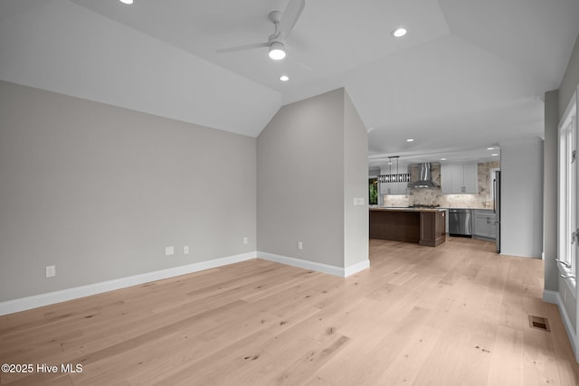 101 Marshview Rd, Hampstead, NC 28443 - unfurnished living room with vaulted ceiling, light wood-style floors, ceiling fan, recessed lighting, and baseboards