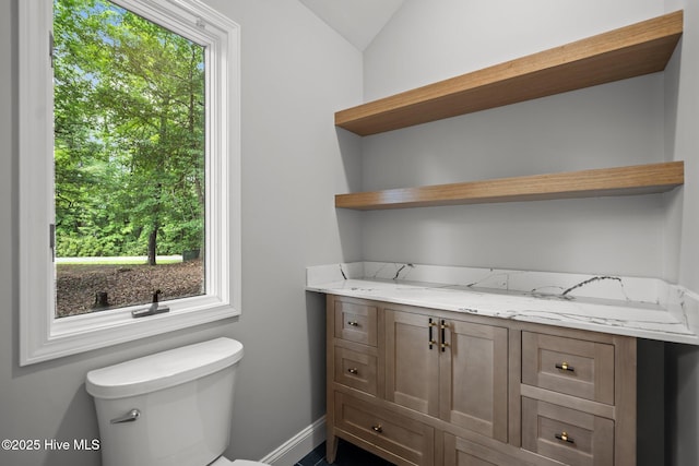 101 Marshview Rd, Hampstead, NC 28443 - half bath featuring plenty of natural light, toilet, lofted ceiling, baseboards, and vanity