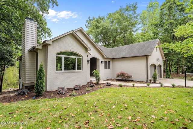 101 Marshview Rd, Hampstead, NC 28443 - single story home featuring a chimney, brick siding, a front lawn, and driveway