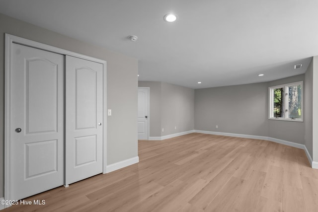 101 Marshview Rd, Hampstead, NC 28443 - unfurnished bedroom featuring light wood-type flooring, baseboards, recessed lighting, and a closet