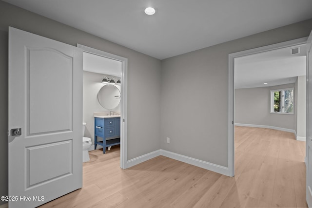 101 Marshview Rd, Hampstead, NC 28443 - unfurnished bedroom with light wood-type flooring, baseboards, and a sink