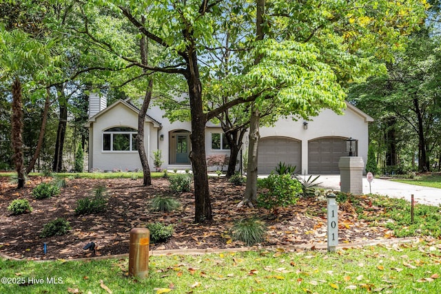 101 Marshview Rd, Hampstead, NC 28443 - view of property hidden behind natural elements with a garage, a chimney, and concrete driveway
