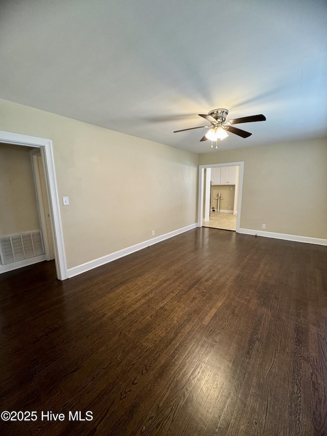 1305 Westwood Ave W, Wilson, NC 27893 - empty room featuring a ceiling fan, dark wood-style flooring, and baseboards
