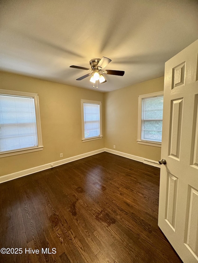 1305 Westwood Ave W, Wilson, NC 27893 - unfurnished room with baseboards, dark wood-style flooring, and ceiling fan