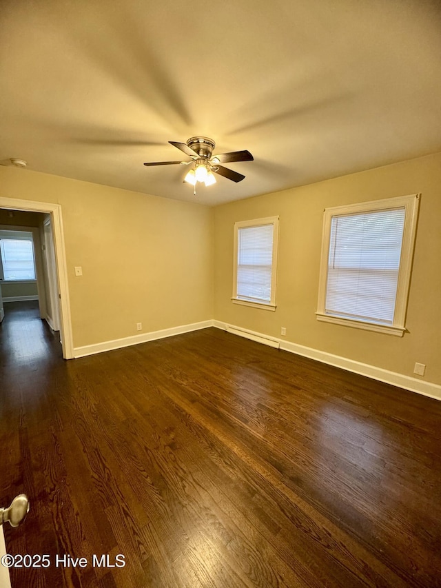 1305 Westwood Ave W, Wilson, NC 27893 - spare room with dark wood-style floors, plenty of natural light, baseboards, and a ceiling fan