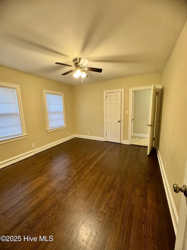 1305 Westwood Ave W, Wilson, NC 27893 - empty room featuring dark wood-style floors, a baseboard radiator, ceiling fan, and baseboards