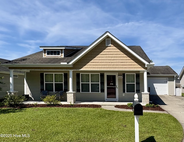 219 Bandon Dr, New Bern, NC 28562 - craftsman-style home with a porch, driveway, a front lawn, and an attached garage