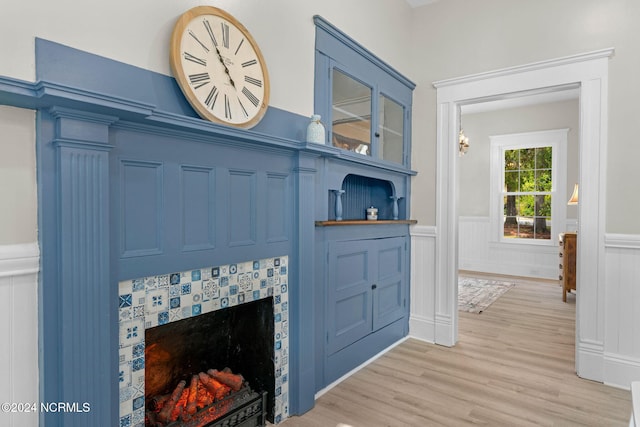 107 Rockingham Rd, Rockingham, NC 28379 - detailed view of wainscoting, wood finished floors, a fireplace, and a decorative wall