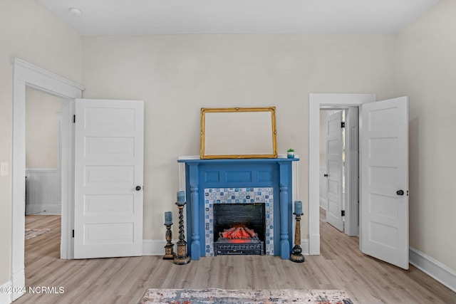 107 Rockingham Rd, Rockingham, NC 28379 - living room with wood finished floors, a tile fireplace, and baseboards