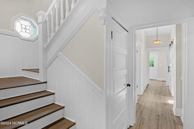 107 Rockingham Rd, Rockingham, NC 28379 - stairs with wood finished floors, a wainscoted wall, and a decorative wall