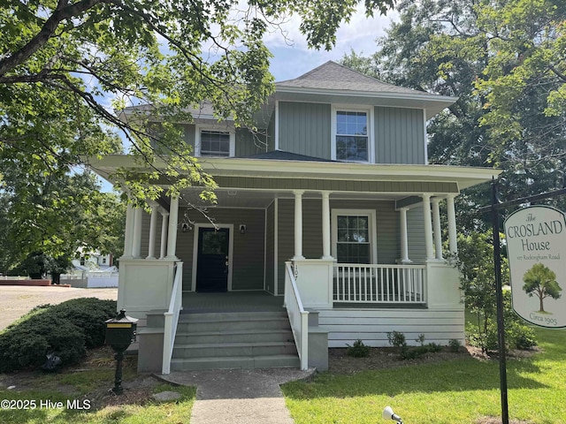 107 Rockingham Rd, Rockingham, NC 28379 - view of front of property with covered porch, a front lawn, and roof with shingles