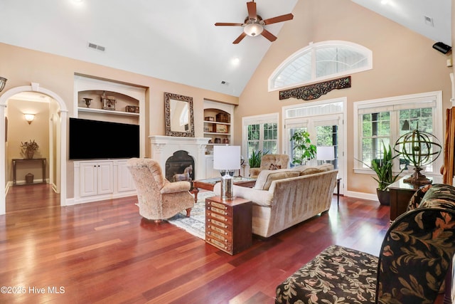 207 Hooping Crane Ln, Goldsboro, NC 27530 - living area featuring built in features, high vaulted ceiling, ceiling fan, a fireplace, and wood finished floors
