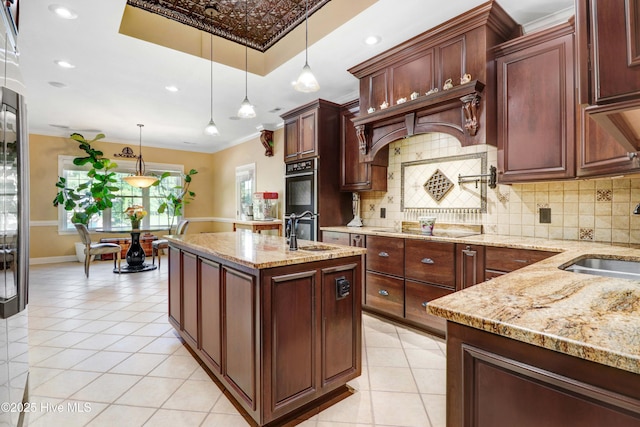 207 Hooping Crane Ln, Goldsboro, NC 27530 - kitchen with a sink, decorative backsplash, an island with sink, ornamental molding, and recessed lighting