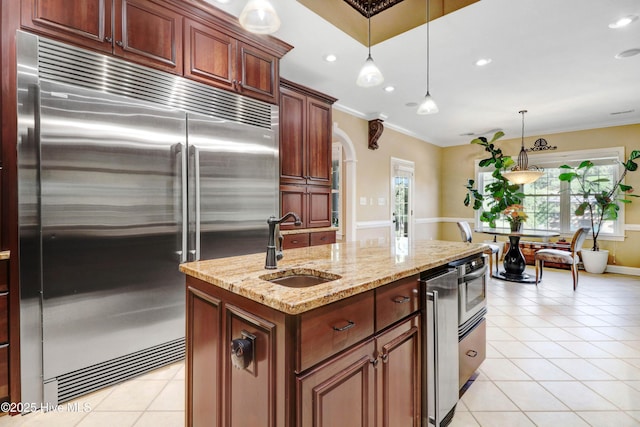 207 Hooping Crane Ln, Goldsboro, NC 27530 - kitchen with stainless steel built in fridge, a sink, light tile patterned floors, ornamental molding, and pendant lighting