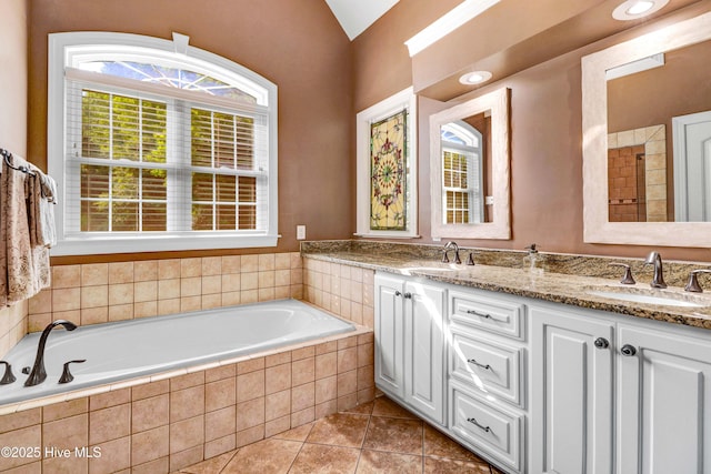 207 Hooping Crane Ln, Goldsboro, NC 27530 - full bathroom featuring tile patterned flooring, a bath, double vanity, and vaulted ceiling