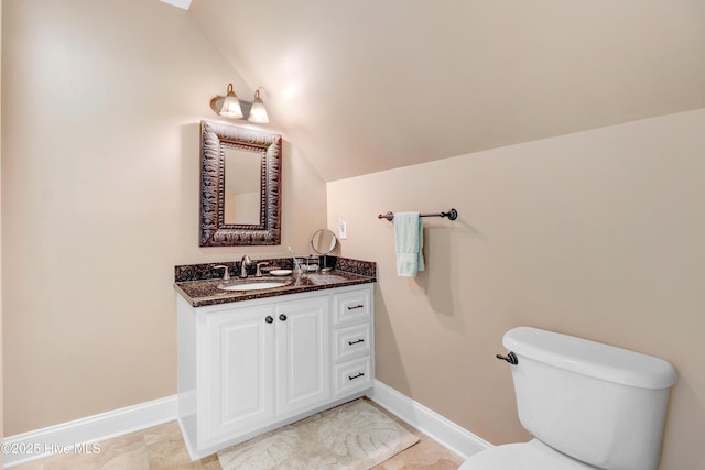 207 Hooping Crane Ln, Goldsboro, NC 27530 - bathroom with baseboards, vanity, vaulted ceiling, and toilet
