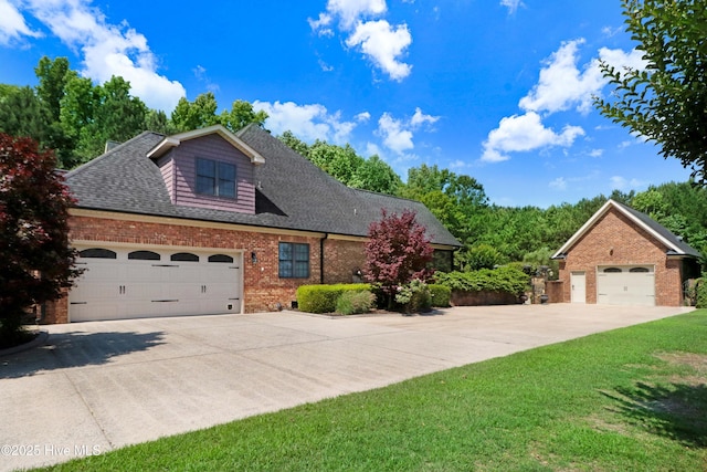 207 Hooping Crane Ln, Goldsboro, NC 27530 - traditional home featuring brick siding, a garage, roof with shingles, and a front yard