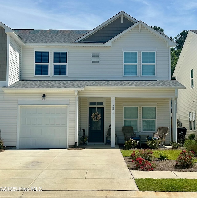 5021 Northstar Dr, Leland, NC 28451 - view of front facade with a porch, an attached garage, concrete driveway, and a shingled roof
