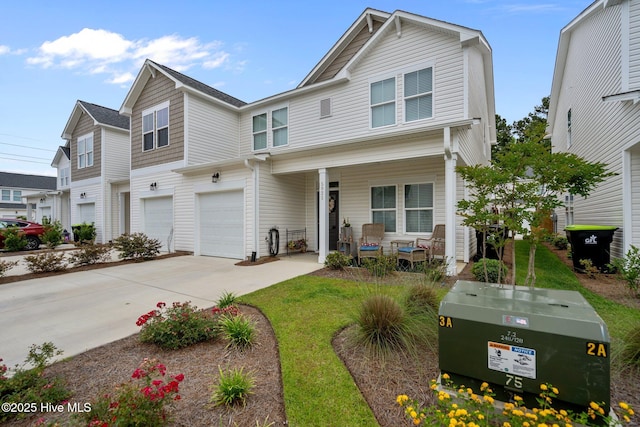5021 Northstar Dr, Leland, NC 28451 - townhome / multi-family property with a porch, concrete driveway, and a garage