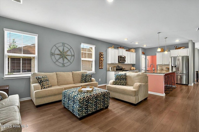 1114 Treyburn Ct NW, Calabash, NC 28467 - living area with dark wood finished floors, recessed lighting, and baseboards
