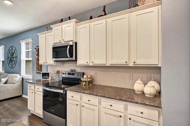 1114 Treyburn Ct NW, Calabash, NC 28467 - kitchen featuring stainless steel appliances, backsplash, dark wood-style flooring, dark stone countertops, and baseboards