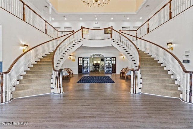 1114 Treyburn Ct NW, Calabash, NC 28467 - foyer entrance with a high ceiling, stairway, wood finished floors, a chandelier, and arched walkways