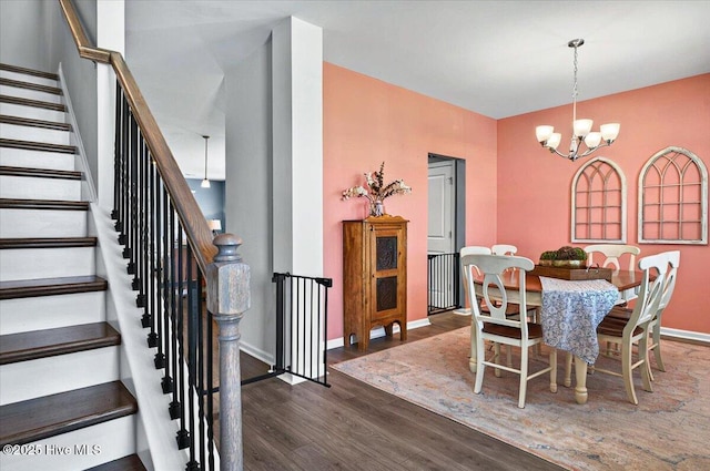 1114 Treyburn Ct NW, Calabash, NC 28467 - dining area featuring a chandelier, wood finished floors, baseboards, and stairway