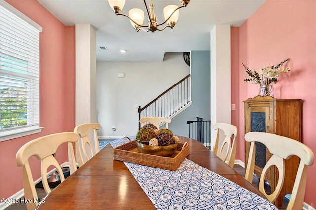 1114 Treyburn Ct NW, Calabash, NC 28467 - dining area with baseboards, stairs, a chandelier, and wood finished floors