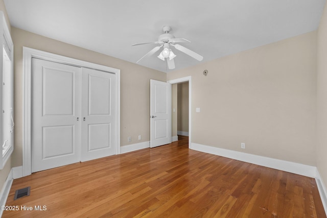 905 N Anderson Blvd, Topsail Beach, NC 28445 - unfurnished bedroom featuring baseboards, light wood-style floors, a closet, and a ceiling fan