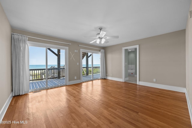 905 N Anderson Blvd, Topsail Beach, NC 28445 - unfurnished room featuring ceiling fan, wood finished floors, a water view, and baseboards