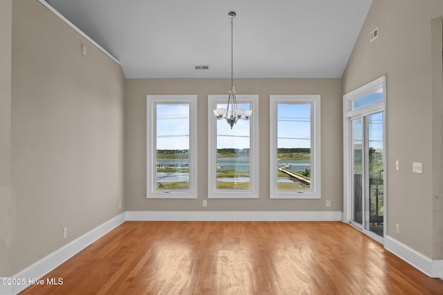 905 N Anderson Blvd, Topsail Beach, NC 28445 - unfurnished dining area featuring light wood-type flooring, a chandelier, baseboards, and lofted ceiling
