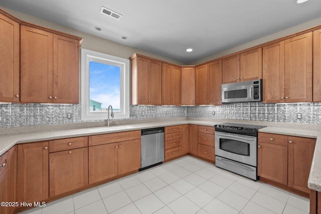 905 N Anderson Blvd, Topsail Beach, NC 28445 - kitchen with appliances with stainless steel finishes, a sink, light countertops, decorative backsplash, and recessed lighting