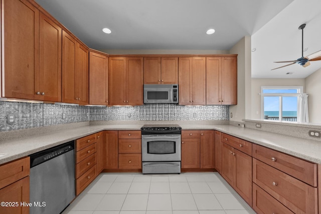 905 N Anderson Blvd, Topsail Beach, NC 28445 - kitchen featuring stainless steel appliances, light countertops, brown cabinets, tasteful backsplash, and a ceiling fan