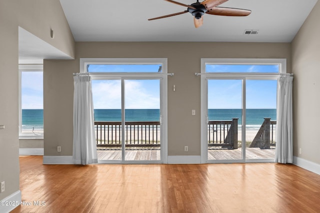 905 N Anderson Blvd, Topsail Beach, NC 28445 - spare room with wood finished floors, a ceiling fan, baseboards, and a water view