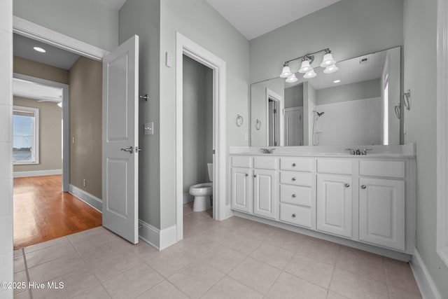 905 N Anderson Blvd, Topsail Beach, NC 28445 - bathroom with toilet, double vanity, baseboards, and tile patterned flooring